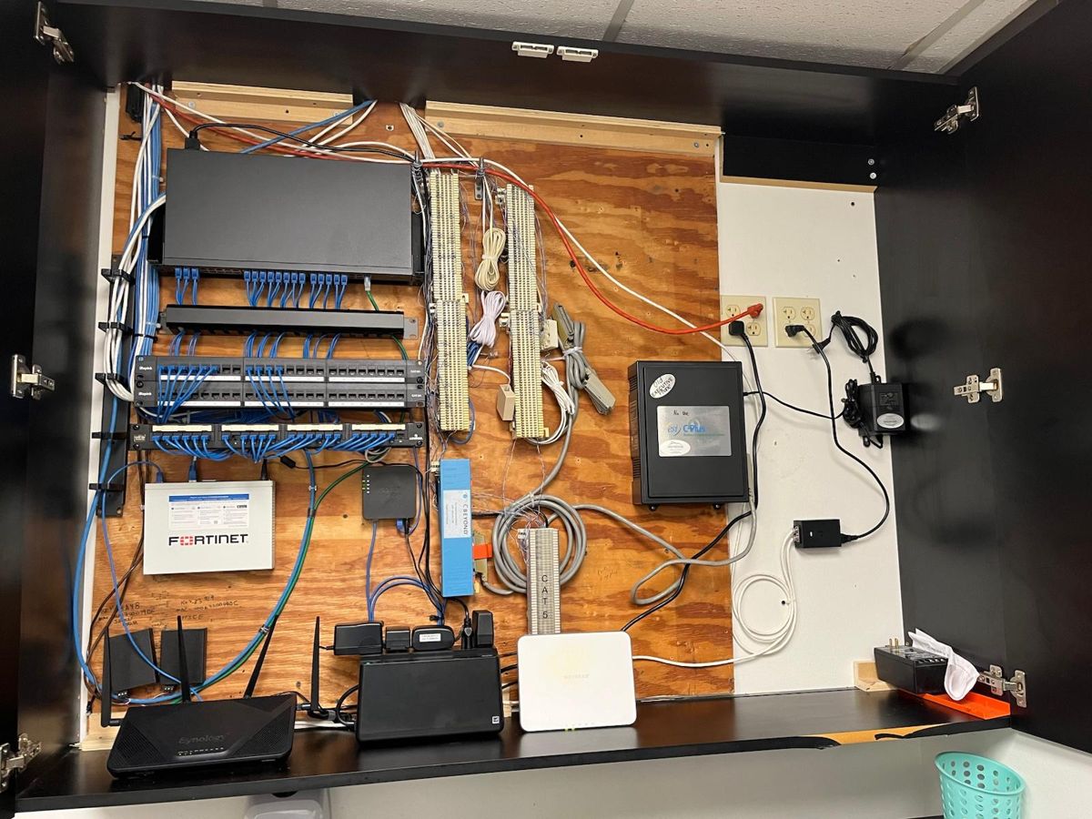 Same network cabinet after: organized cabling and mounted equipment
