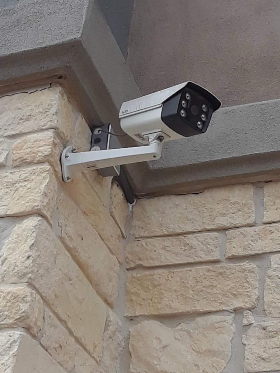 Bullet camera mounted on a stone wall corner